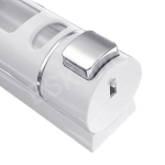 Close-up of the dispenser spout and button on a white wall-mounted soap dispenser.